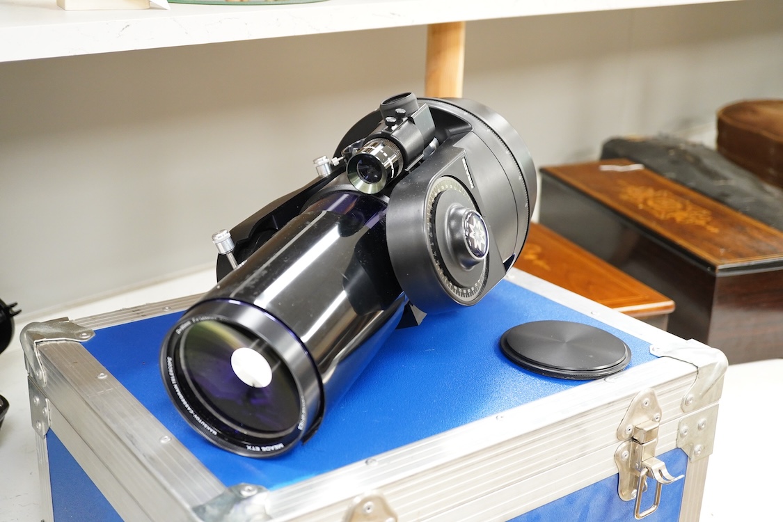 A cased Meade ETX Astro telescope, with instruction manual contained within the original flight case, 46 x 36 x 23cm, together with an additional Orion glass solar filter and tripod